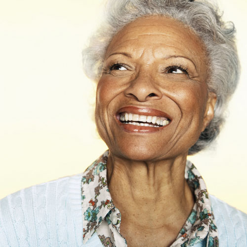 Older Black woman smiling with dental implants from Mission Hills Periodontics in San Diego, CA